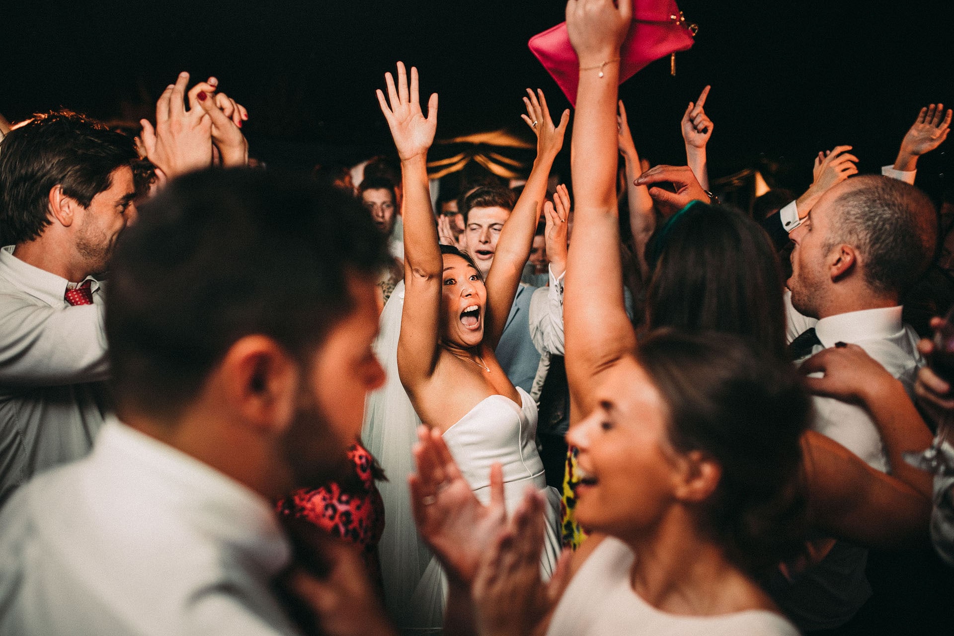 The dance floor erupting, bride with her arms in the air
