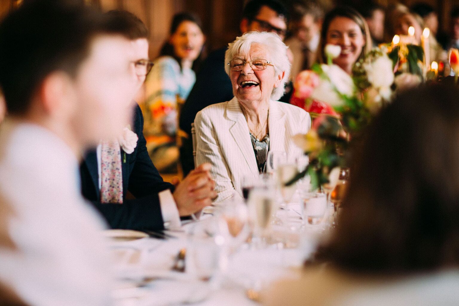 Older guest laughing at the table