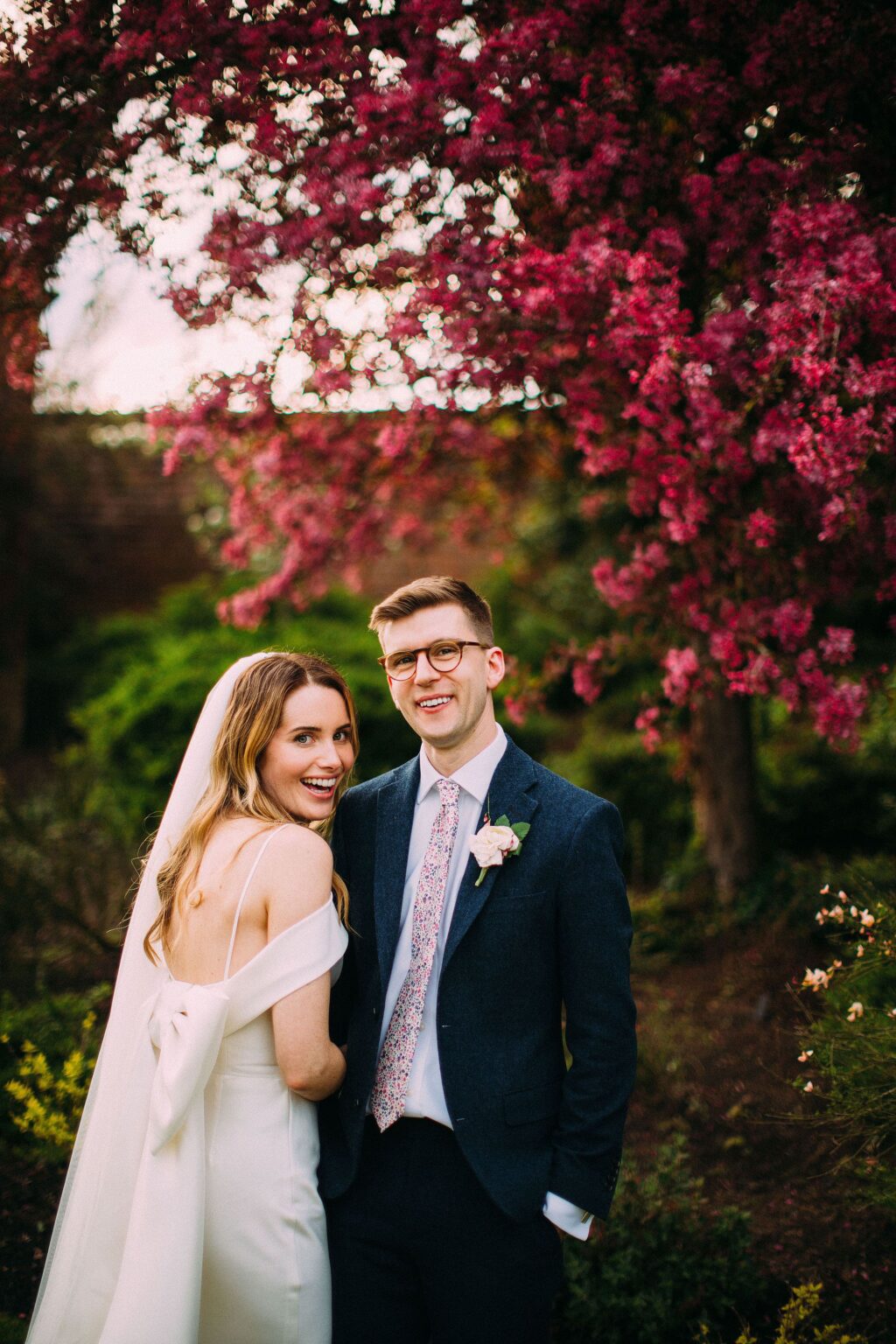 Couple sharing a laugh among the blossom