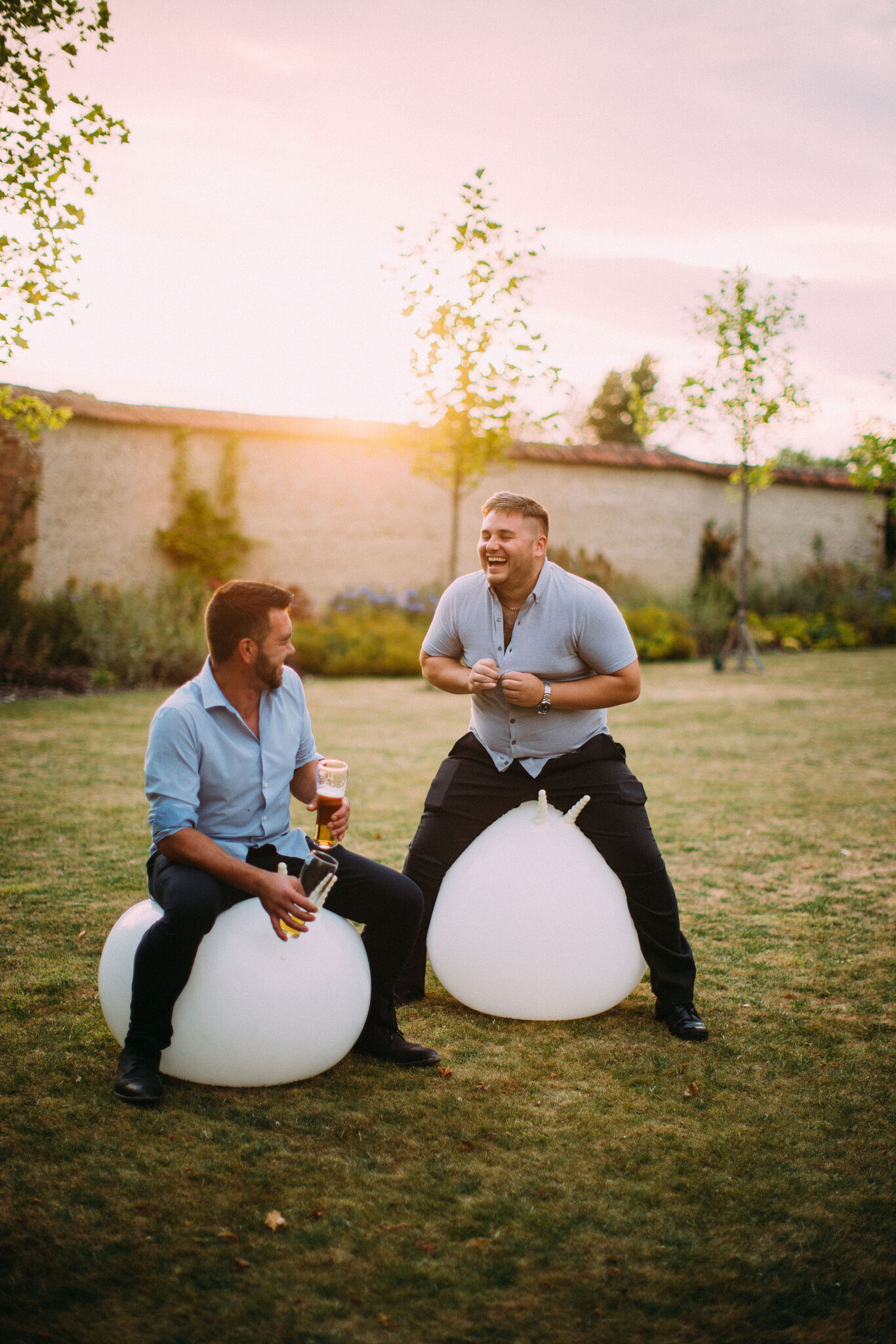 Wedding guests laughing together on the lawn